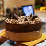 Decadent whole chocolate cake with chocolate ribbons on top