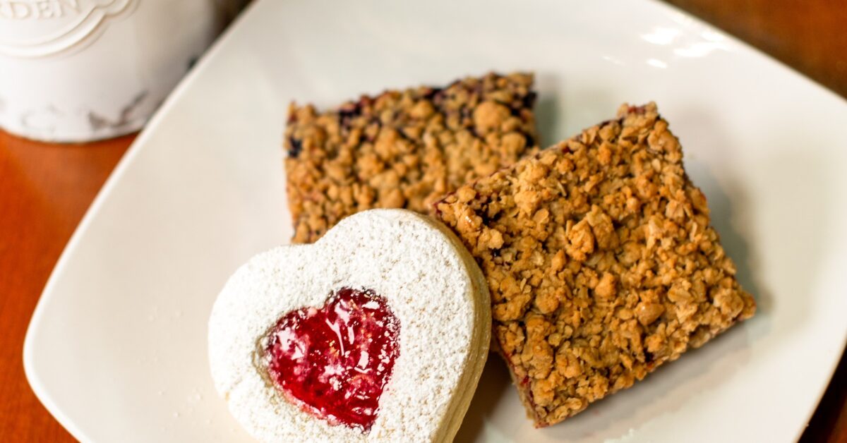 Plate of a raspberry-filled sugar cookie and assorted fruit oat bars